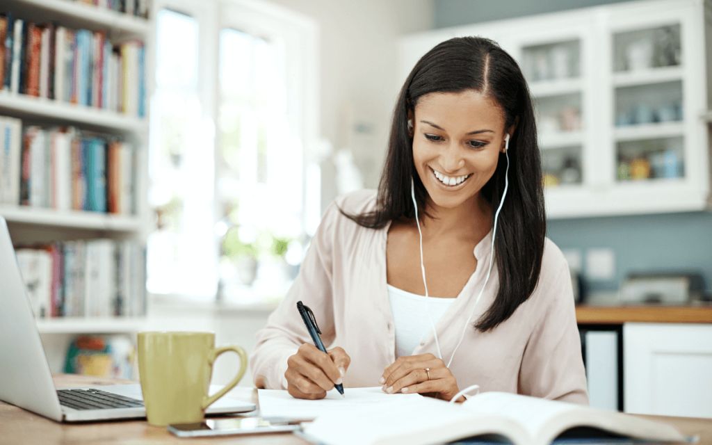 a woman listening to music while she works to improve productivity